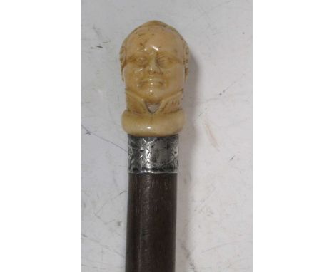 A carved ivory Napoleon head walking stick pommel, with mahogany shaft, 82.5cm long