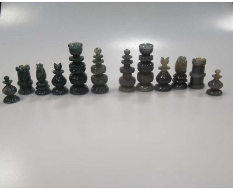 An East European composition chess set in, metal mounted, with stylised pieces; another chess set in stained wood with carved