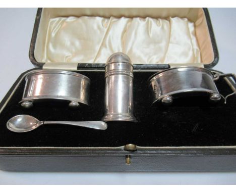 A cased silver three-piece condiment set, all with blue glass liners - one spoon lacking