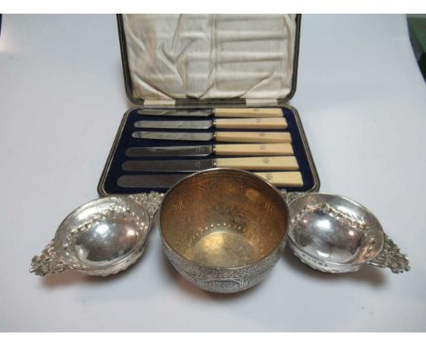 A silver sugar bowl, two silver tea strainer stands and a cased set of silver and mother of pearl fruit eaters, together with