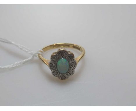 An opal and diamond cluster ring, unhallmarked, stamped '18CT &amp; PLAT', weight 2.7g