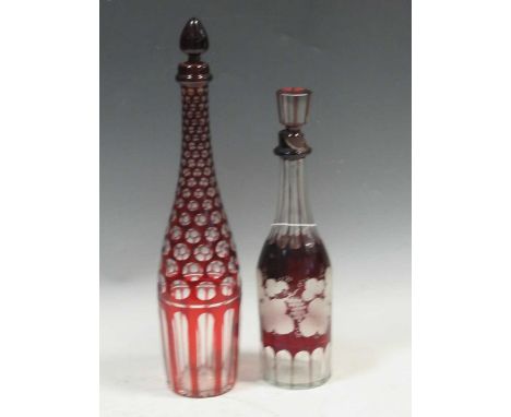 A Bohemian ruby-flashed decanter and stopper, 41cm hjigh; another engraved with vines, 33cm high