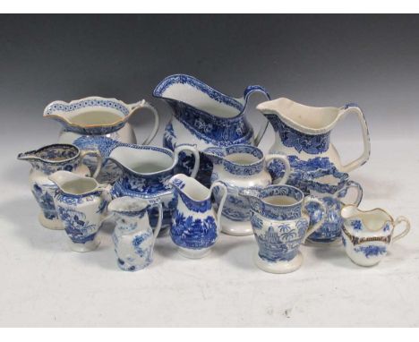 A collection of blue and white jugs to include a Victorian blue and white owl jug, a Cauldon Byzantine pattern jug, a Masons 