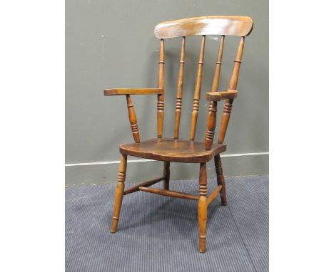 A beechwood stick back kitchen armchair