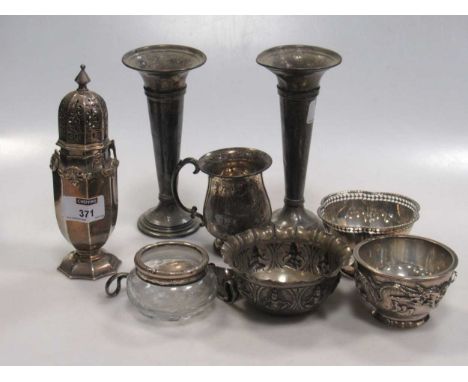 A collection of silverware including a sugar caster, christening mug, a pair of trumpet shape specimen vases with loaded base