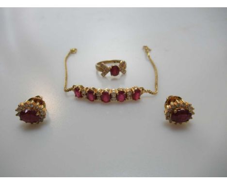 A glass filled ruby and diamond ring, stamped '750', together with a pair of glass filled ruby and diamond ear studs, stamped