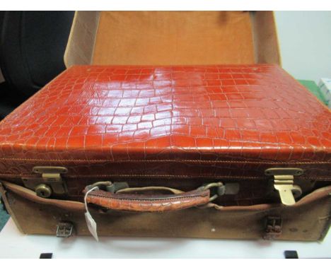 A crocodile skin vanity case by JW Benson with canvas outer cover, containing three silver topped glass jars, a silver backed