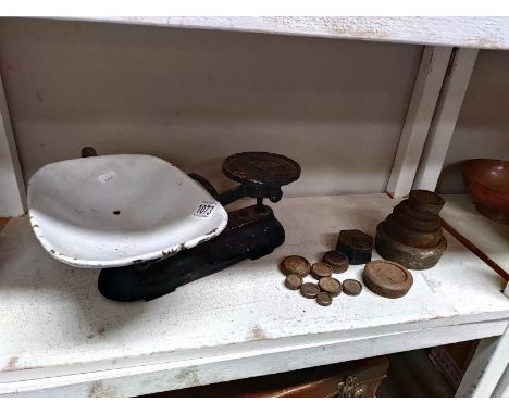 A set of weighing scales and weights in a vintage port crate.