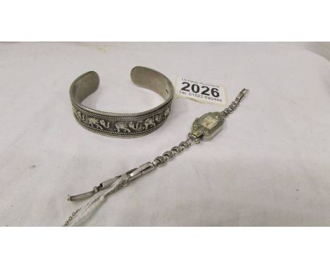 A silver elephant design bangle and a marcasite cocktail watch.