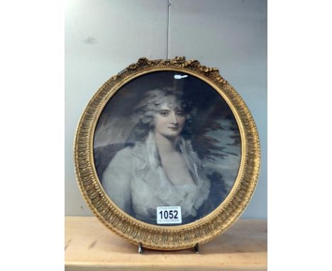 An oval framed and glazed print of a lady. 41cm x 35cm. (frame a/f)