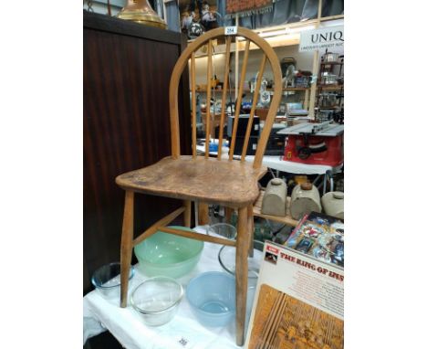A blonde Ercol stick back Windsor chair