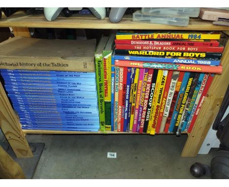 A shelf of 70's 80's and 90's annuals and a set of Disney "World of Knowledge"
