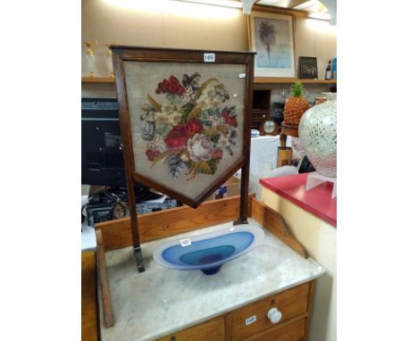 A 1930's oak fire screen with wool work tapestry panel behind glass. 49cm x 74cm 