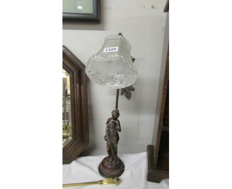 A figural table lamp with glass shade (needs re-wiring).