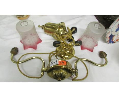 A Victorian brass rise and fall ceiling light with two original glass shades in perfect condition.