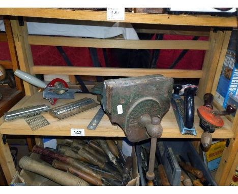 A shelf of tools including a quick release vice.