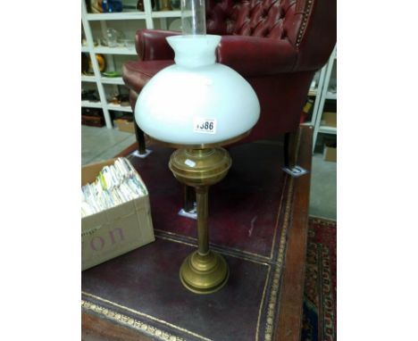 A brass column oil lamp with white mushroom shade