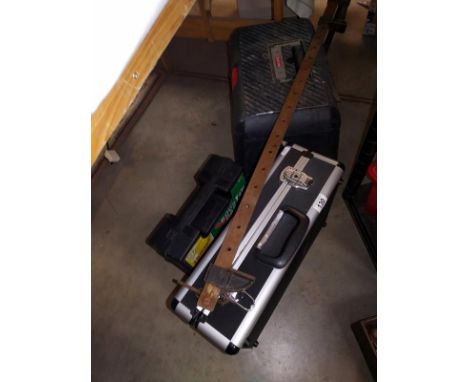 An aluminium case full of tools, booster cables, toolbox step and a clamp.