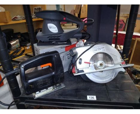 A boxed Performance Orbital sander and a Black and Decker jigsaw and a circular saw.