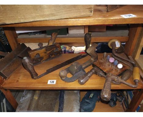 A shelf of wood planes etc