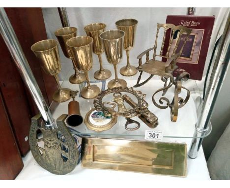 A shelf of brassware