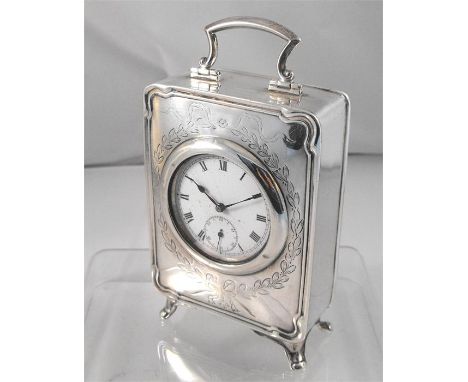 A silver time piece, the enamel dial with Roman Numerals and subsidiary seconds dial with engraved leaf and ribbon decoration