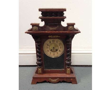 A Victorian mantle clock the paper dial having Arabic numerals in a walnut veneered case, 51cm high  