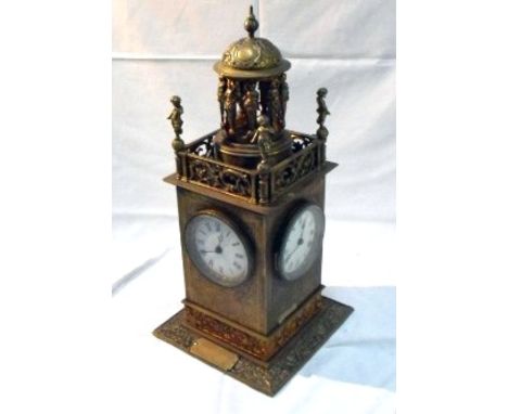 A very ornate 19thC brass centre table clock with four enamel dials driven from a single movement surmounted with cherubs and