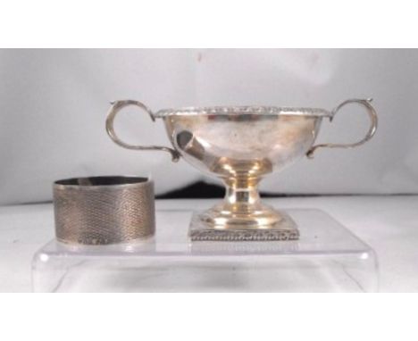 A George V two handled silver salt, London 1919, 6cm high and a silver napkin ring 97g 