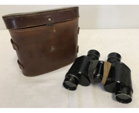 A leather cased pair of binoculars, WWII war dept arrow stamped.  
