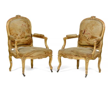 A pair of Louis XV fauteuilsCarved and gilt woodAubusson type tapestry upholstery to backs, arms and seats, depicting scenes 