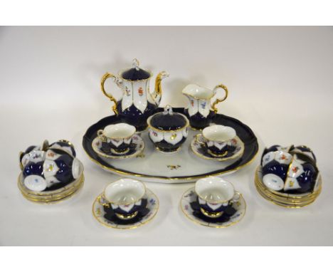 A Meissen porcelain cabaret coffee service, the dark blue body with gilt lined petal shaped panels painted with floral sprigs