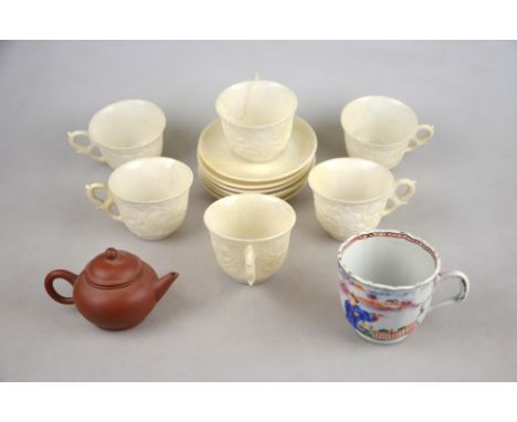 A set of six hardstone Chinese Shanghai teacups and saucers carved with dragons chasing a flaming pearl to/w a Canton famille