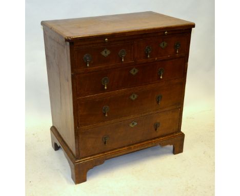 A small 19th century feather-banded walnut chest comprising a slide over two short and three long graduated drawers, raised o
