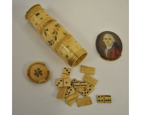 A Napoleonic Prisoner of War work turned bone dice-box with incised and coloured decoration and screw ends, containing a play