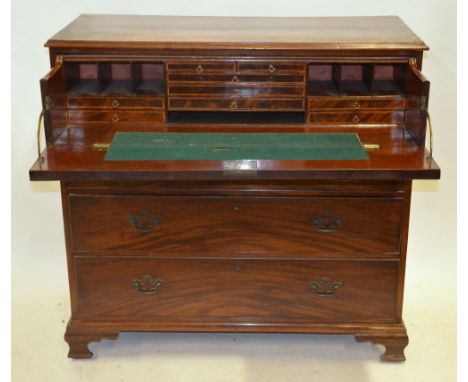 A George III mahogany secretaire chest having a well-fitted stationery drawer over three long cockbeaded edge drawers, raised