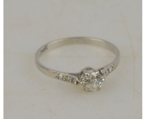 A single stone old cut diamond ring having three eight-cut diamonds on each shoulder, white metal setting, stamped plat, size