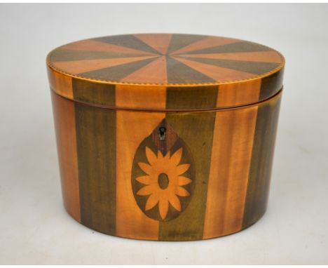 A Sheraton style oval tea caddy with bands of satinwood and mahogany veneer, chevron-strung edge, with floral marquetry medal