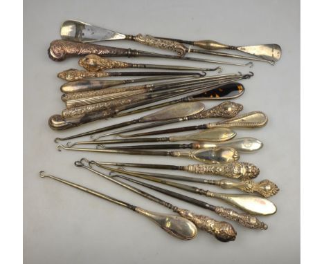 A collection of twenty-two large button hooks - mostly with silver handles, to/w two shoe horns (24)
