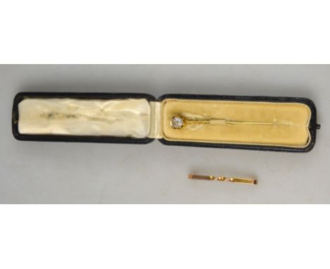 An oval paste-set stick pin in fitted case, to/w twist style tie pin stamped 9ct