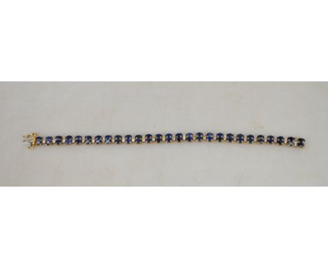 A double row claw set oval sapphire and diamond line bracelet, 19 cm long, set 9ct, approx 13g all in