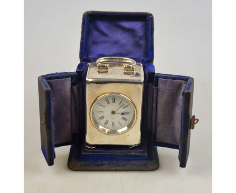 A small silver carriage clock with French movement and enamelled dial, Henry Matthews, Birmingham 1903, 9 cm high (including 