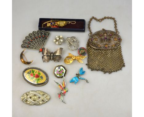 A continental evening purse with butterfly motif and amethyst glass jewelling to/w various costume jewellery brooches, and an