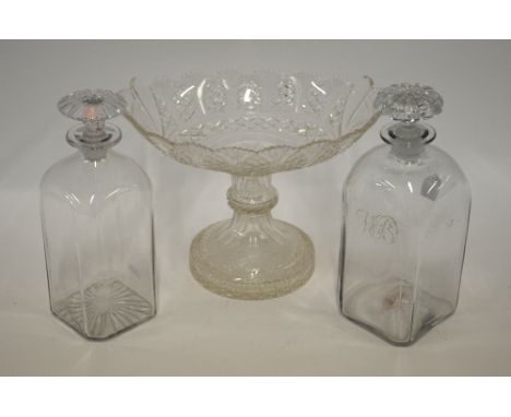 A pair of 19th century square glass decanters, one having a star cut base, the other a rough pontil, and both with mushroom s