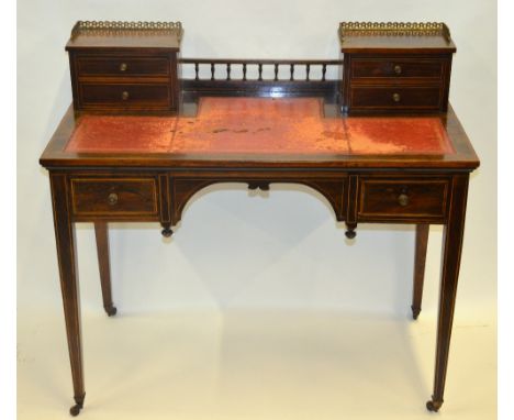 A Victorian inlaid rosewood writing table in the manner of Edwards & Roberts, the top with gallery top, short drawers and ins
