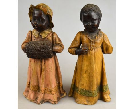 A pair of Goldscheider figures of Negro children, early 20th century, factory marks to underside of dress, 25 cm h. (2) Condi