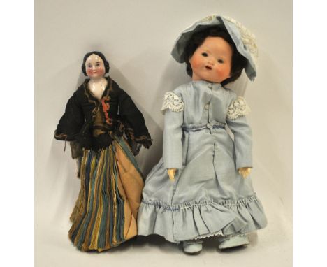 An unusual Victorian fortune-telling doll with china head and fore-limbs, wearing a skirt of coloured paper leaves, each unfo