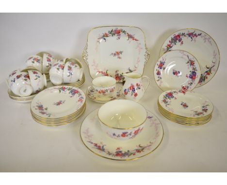 A Wedgwood floral decorated tea service comprising 12 teacups, 12 saucers, 12 plates, 2 circular cake plates, square sandwich