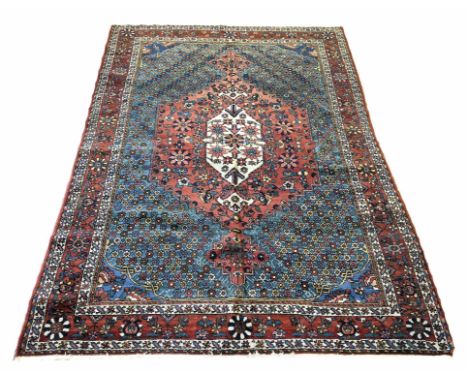 FINE ANTIQUE BAKTIAR RUG, 207cm x 150cm, pendant medallion on a floral field within corresponding bands and borders.