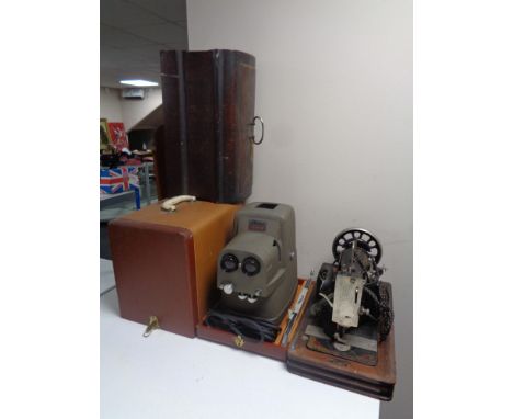 A cased vintage Vesta sewing machine (electrified) together with a cased Vivid stereo projector 